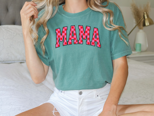 a woman sitting on top of a bed wearing a green shirt