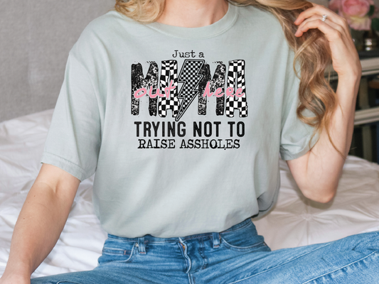 a woman sitting on a bed wearing a t - shirt