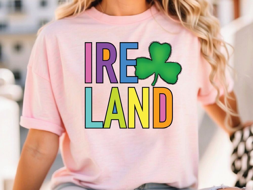 A woman wearing a pink t-shirt with the text "IRELAND" and a green shamrock graphic printed on it.