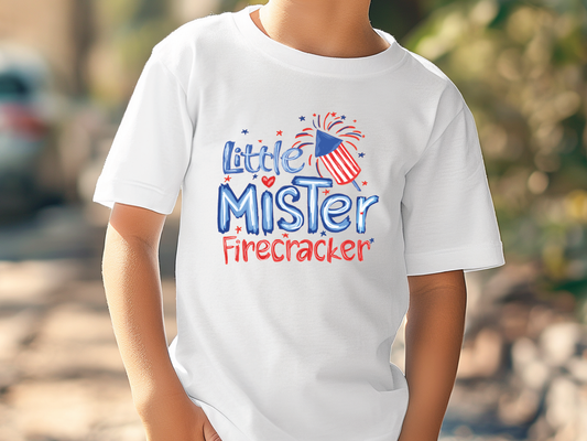 a young boy wearing a little mister firecracker t - shirt