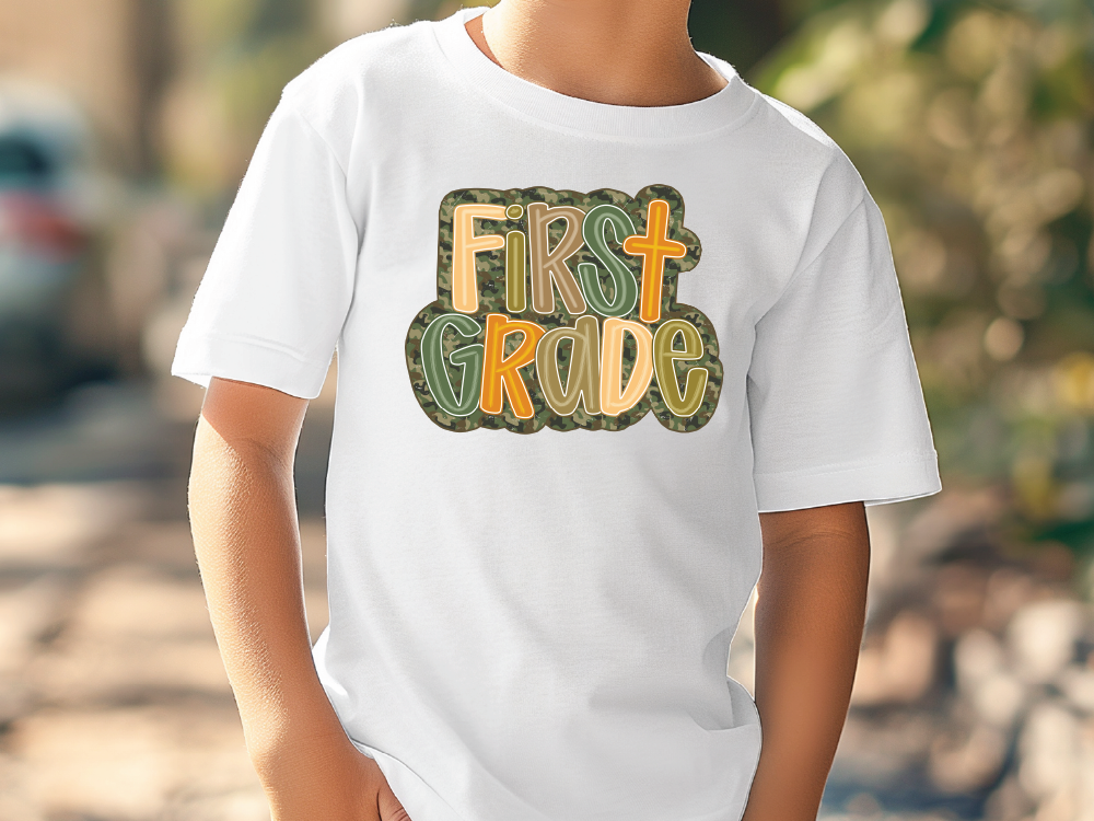 a young boy wearing a white shirt with the words first grade printed on it