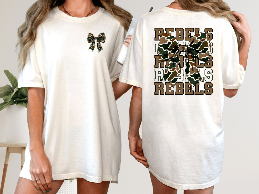 A woman wearing a white t-shirt with a camouflage print and the word "REBELS" printed on the back.
