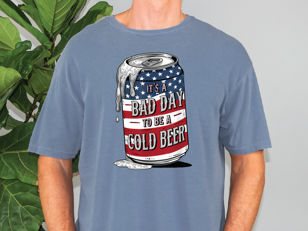 a man wearing a blue shirt with a can of beer printed on it