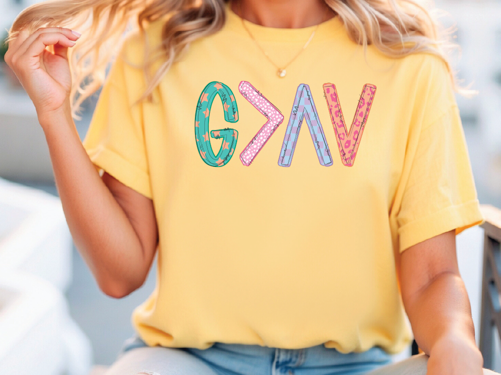 a woman wearing a yellow shirt with the word vkg on it