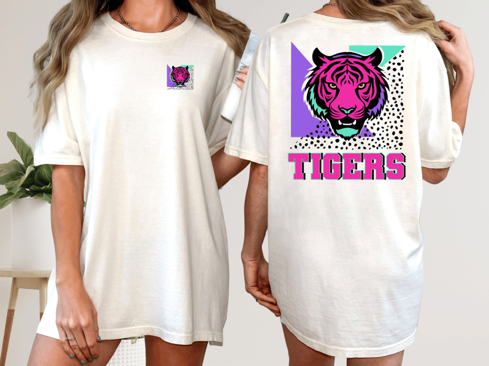 A woman wearing a white t-shirt with a graphic of a tiger and the word "TIGERS" printed on the back.