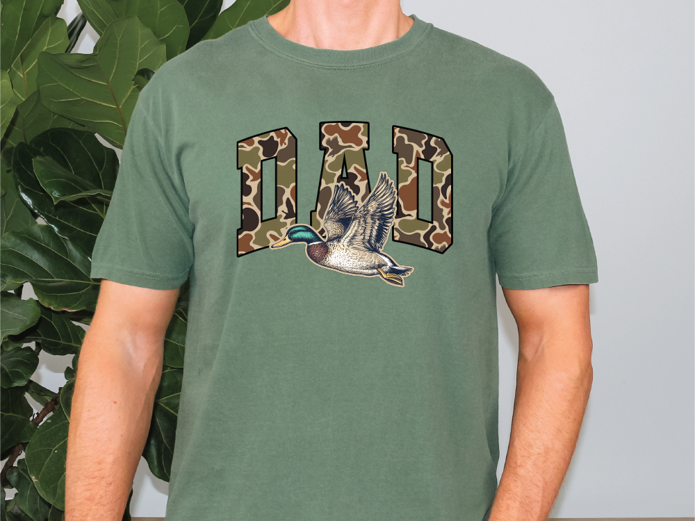 a man wearing a green shirt with a duck on it