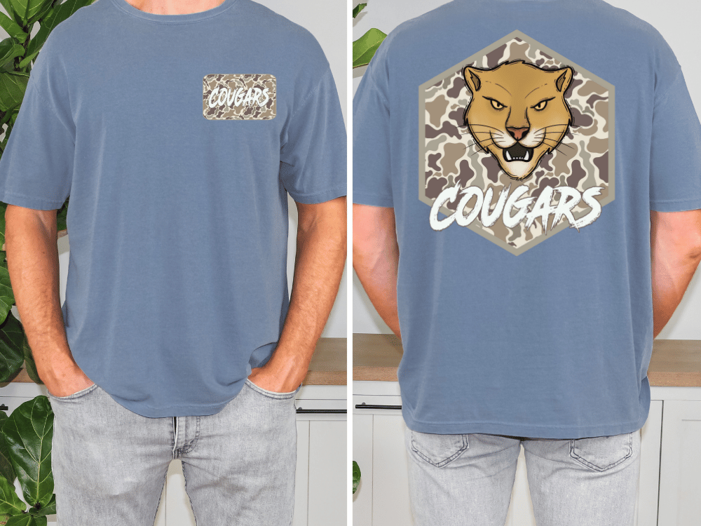 a man wearing a blue t-shirt with a cougar graphic and the word "Cougars" printed on it.