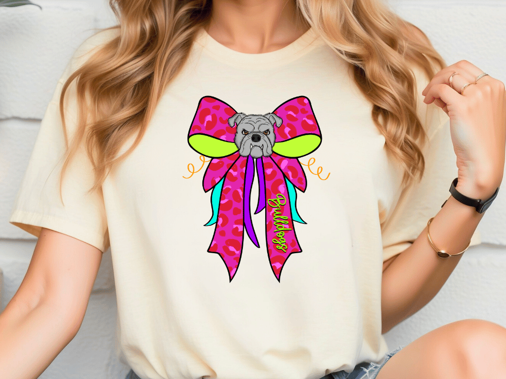 A woman wearing a white t-shirt with a colorful graphic of a dog wearing a pink bow.