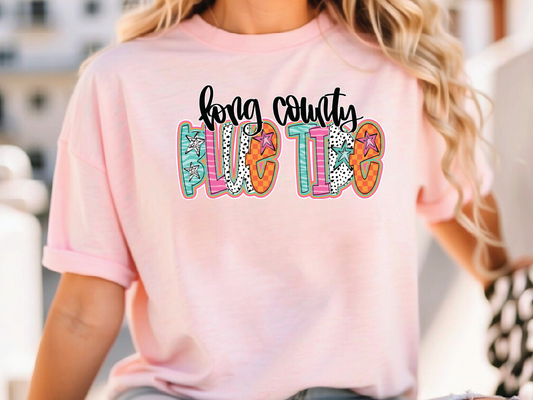 a woman wearing a pink shirt that says king county glitter