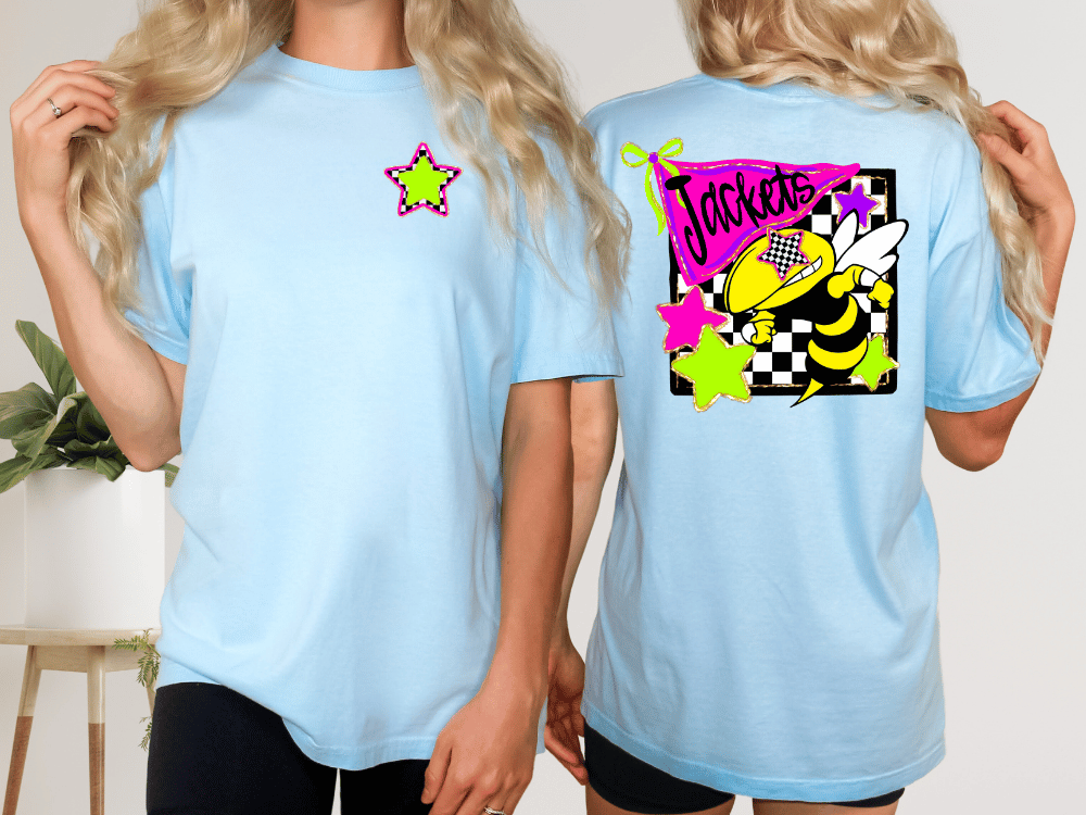 two women wearing light blue t-shirts with colorful designs on the back.