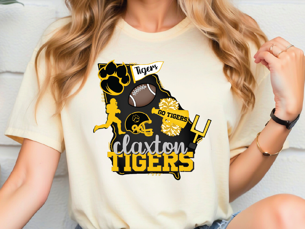 A woman wearing a white t-shirt with a graphic design featuring various sports-related icons and text.