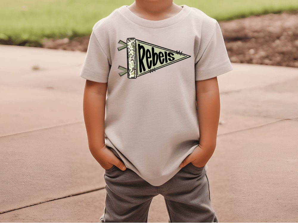 A child wearing a white t-shirt with a graphic of a flag and the word "Rebeys" printed on it.