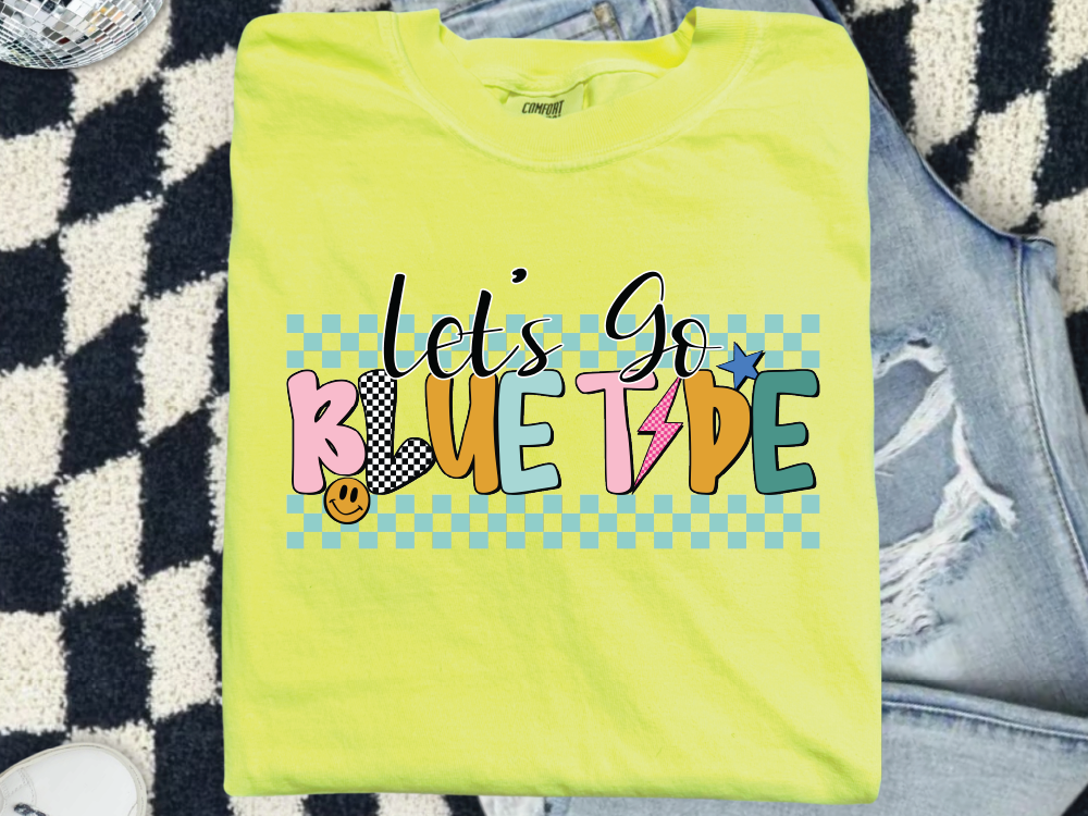 A yellow t-shirt with the text "LET'S GO BLUE TYPE" printed on it, along with various colorful and stylized graphics.