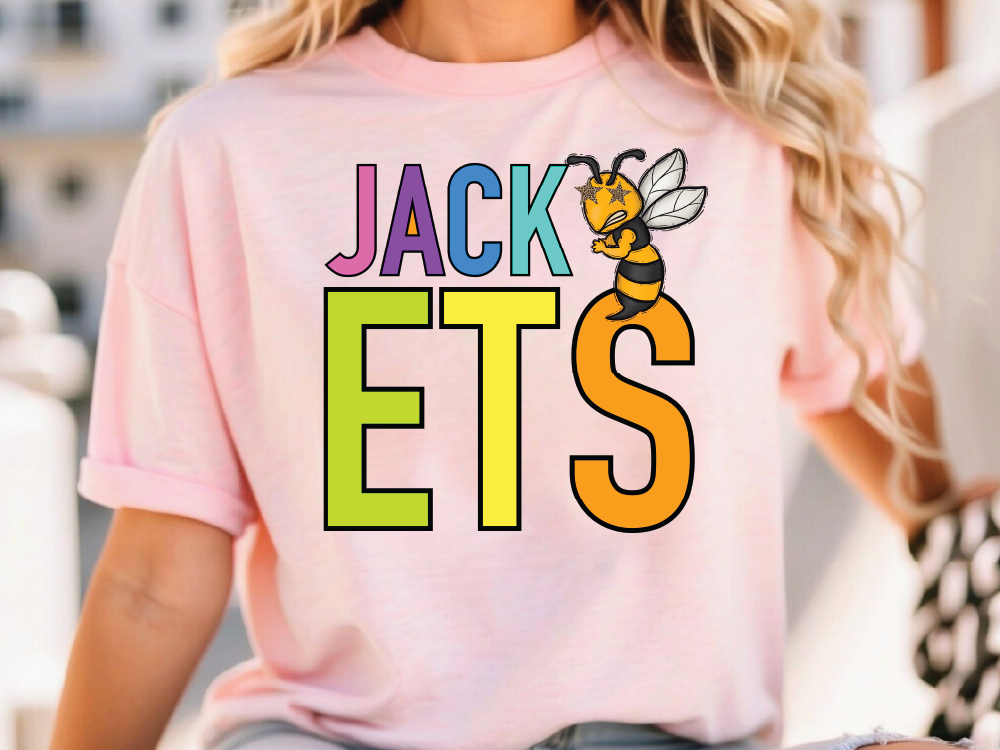 A person wearing a pink t-shirt with the text "JACK ETS" printed on it, along with a cartoon bee graphic.