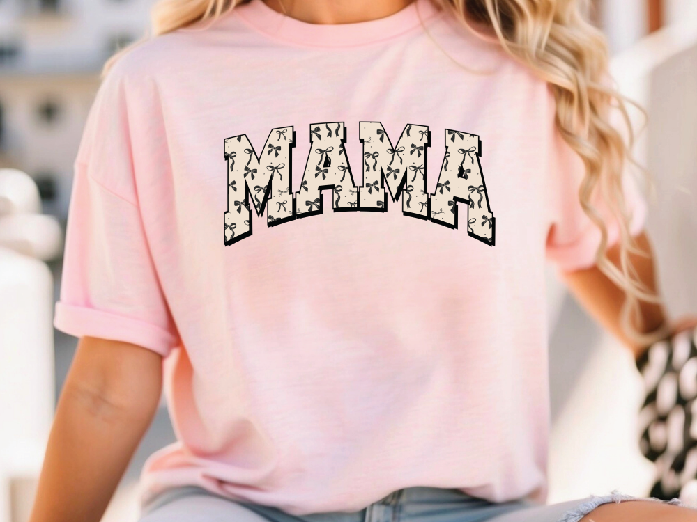 a woman wearing a pink shirt with the word mama printed on it
