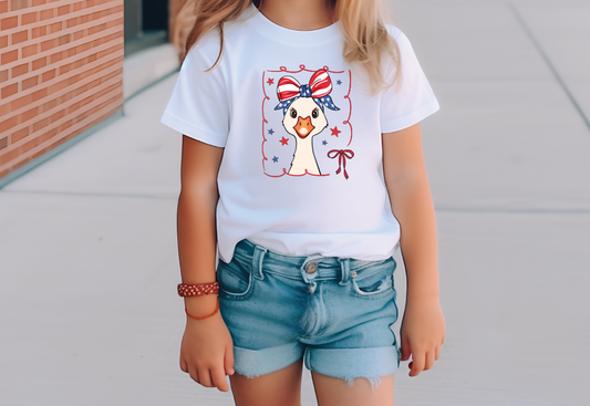 a little girl wearing a patriotic t - shirt and denim shorts