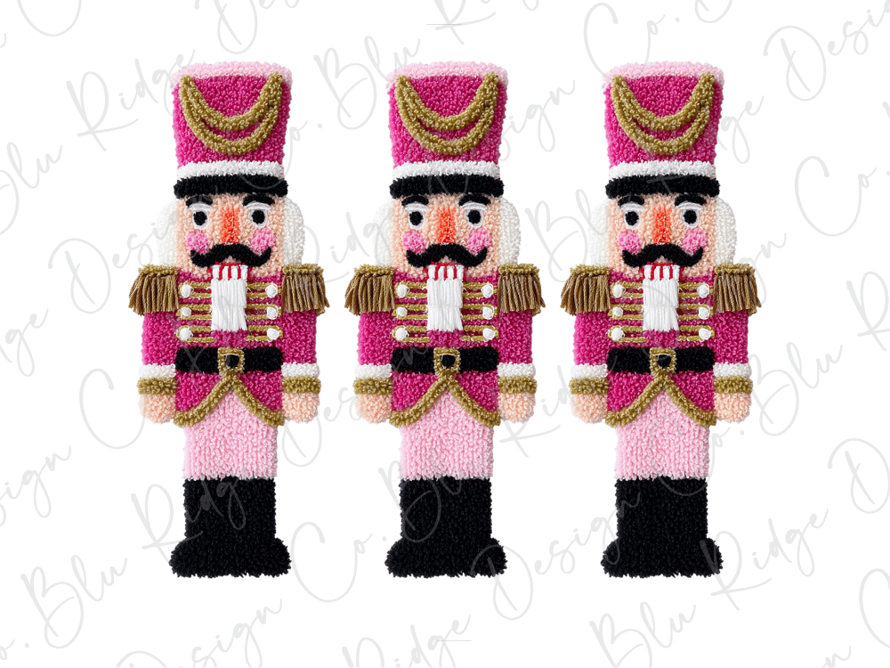 Three nutcracker figurines in a row, each wearing a pink and gold uniform with a hat and a red bow tie.
