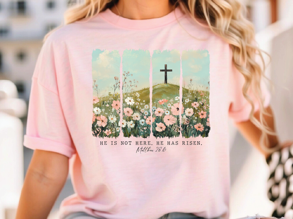 a woman wearing a pink shirt with a cross on it