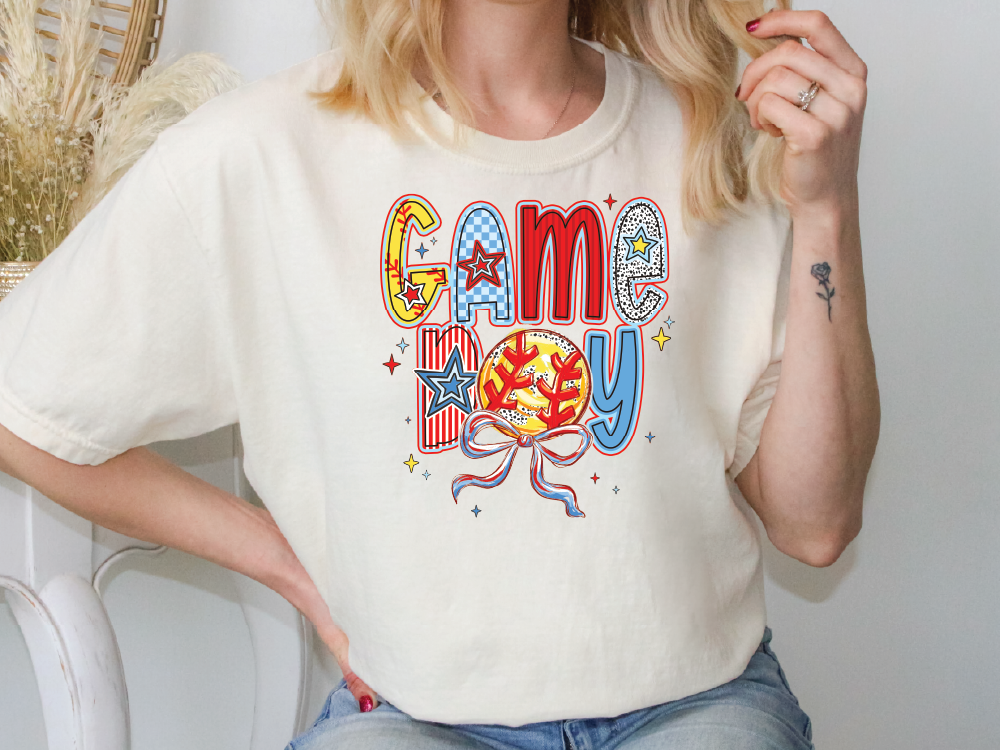 a woman sitting on a chair wearing a game day shirt