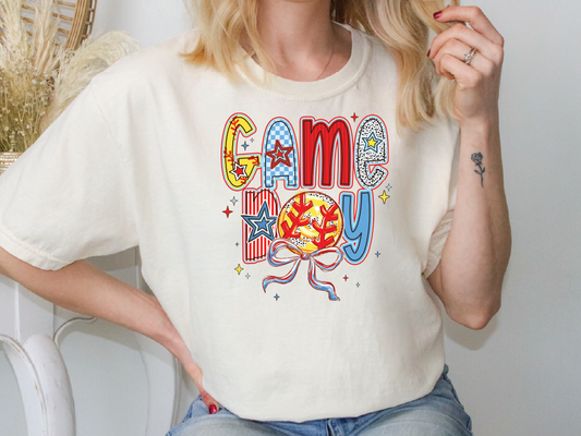 a woman sitting on a chair wearing a game day shirt