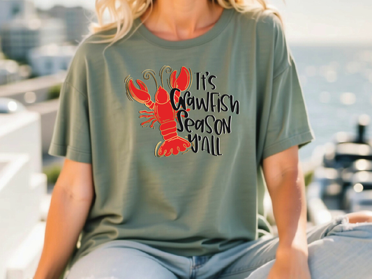 a woman wearing a t - shirt with a lobster on it