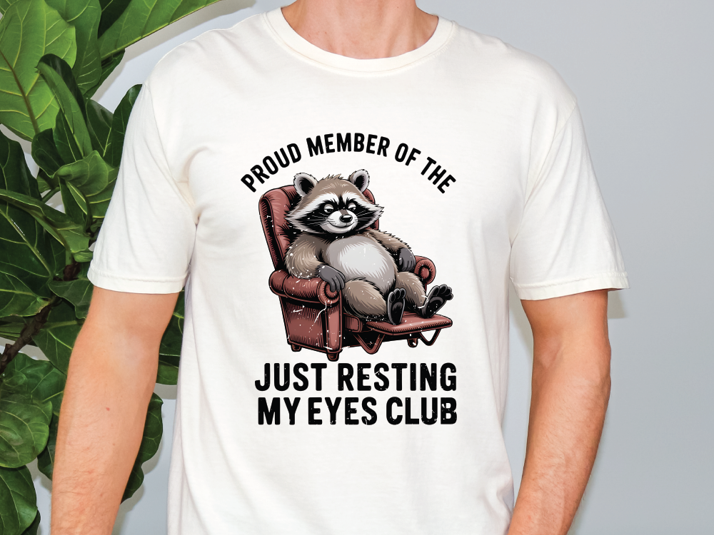 a man wearing a white shirt with a raccoon on it