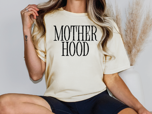 a woman wearing a t - shirt that says motherhood