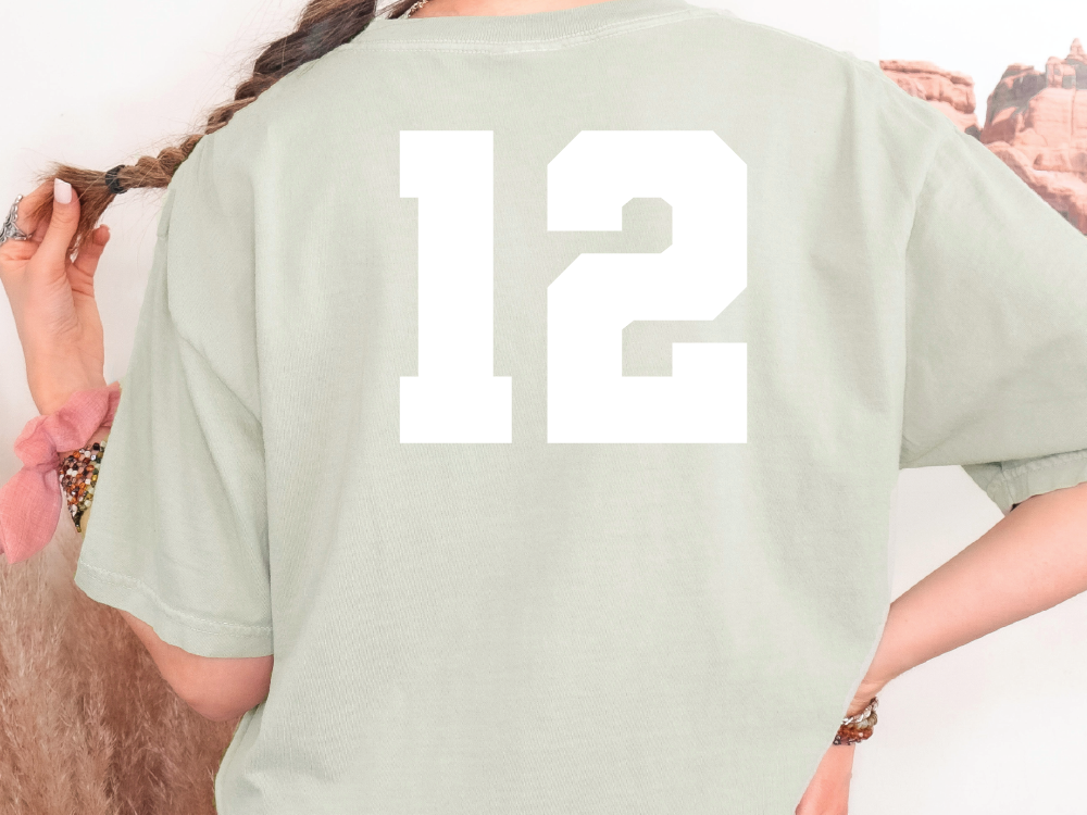 a woman wearing a green shirt with the number twelve on it