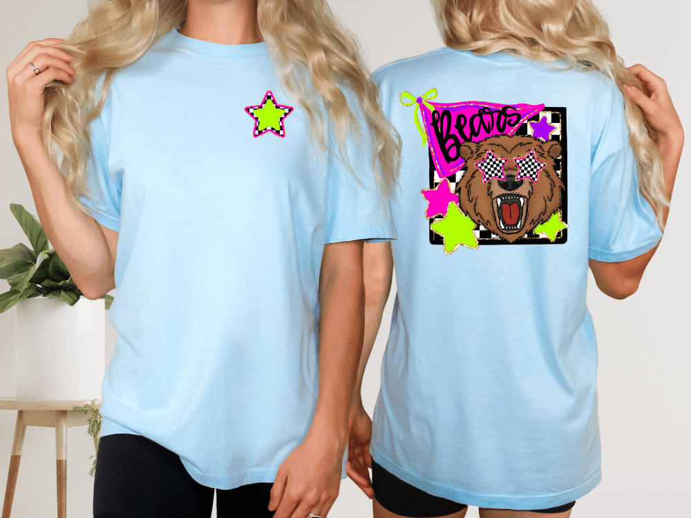 two women wearing light blue t-shirts with a graphic design on the back.