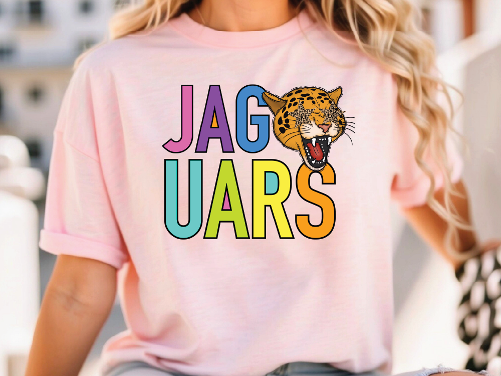 A woman wearing a pink t-shirt with the word "JAGUARS" printed on it, along with a graphic of a jaguar's head.