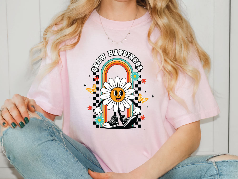a woman wearing a pink shirt with a daisy on it