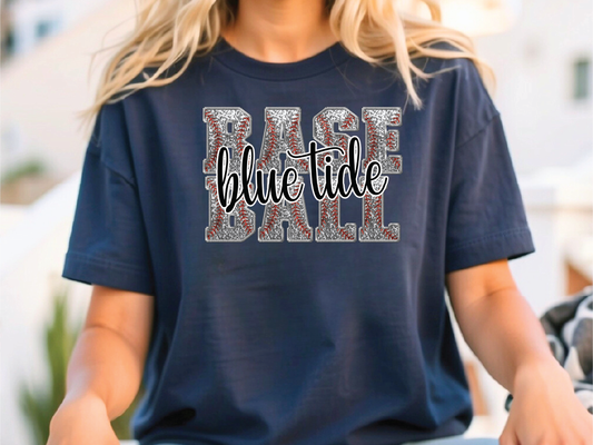 a woman sitting on a skateboard wearing a blue shirt