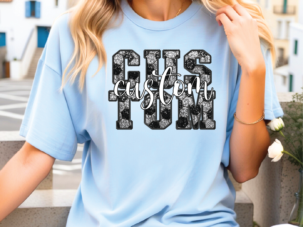 a woman wearing a light blue tshirt with the words gus and fun printed