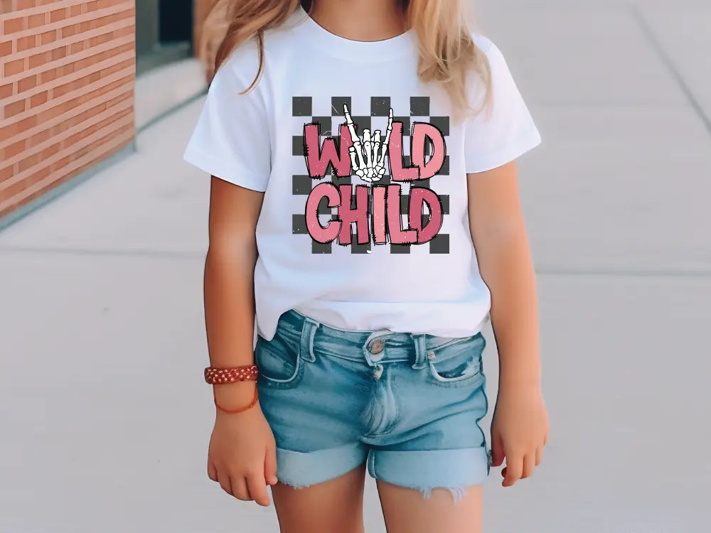 a little girl wearing a white shirt and denim shorts