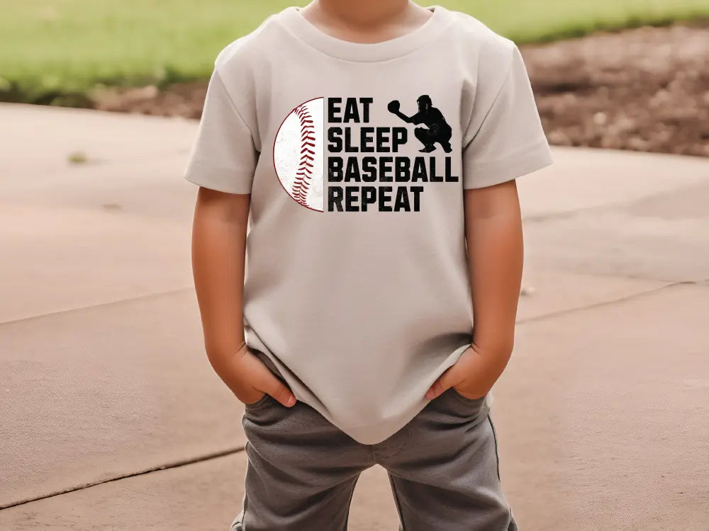 a young boy wearing a t - shirt that says eat sleep baseball repeat