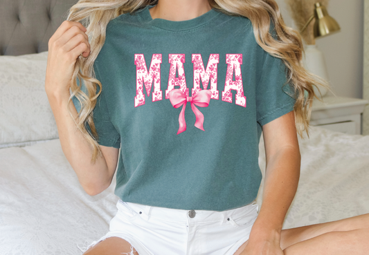 a woman sitting on top of a bed wearing a green shirt