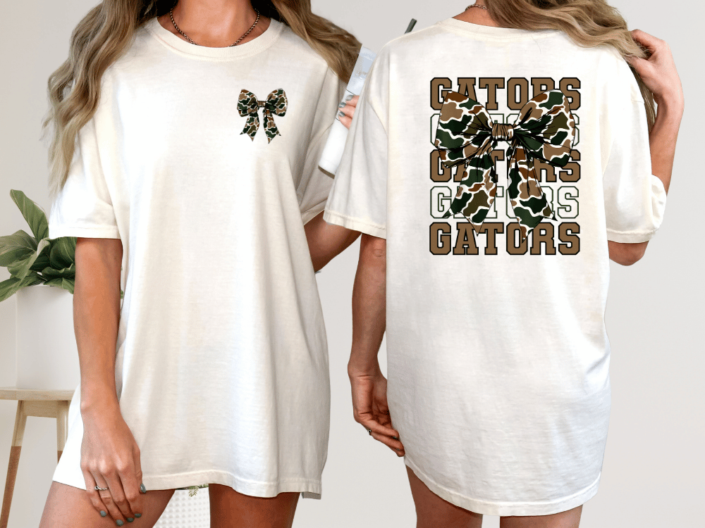 A woman wearing a white t-shirt with a bow and the word "GATORS" printed on the back.