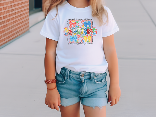 a little girl wearing a white shirt and blue shorts