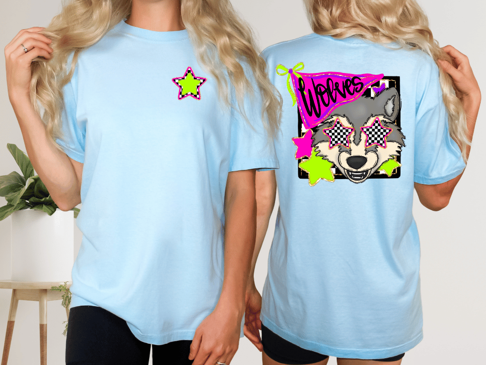 two women wearing light blue t-shirts with a graphic design featuring a wolf wearing sunglasses.