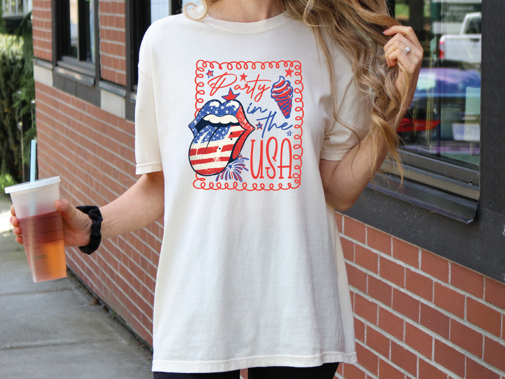 a woman holding a cup of coffee and wearing a t - shirt