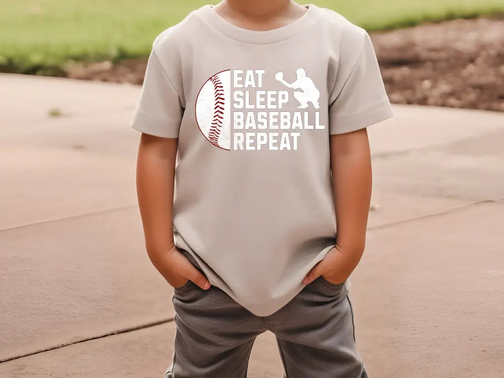 a little boy that is wearing a shirt that says eat sleep baseball repeat