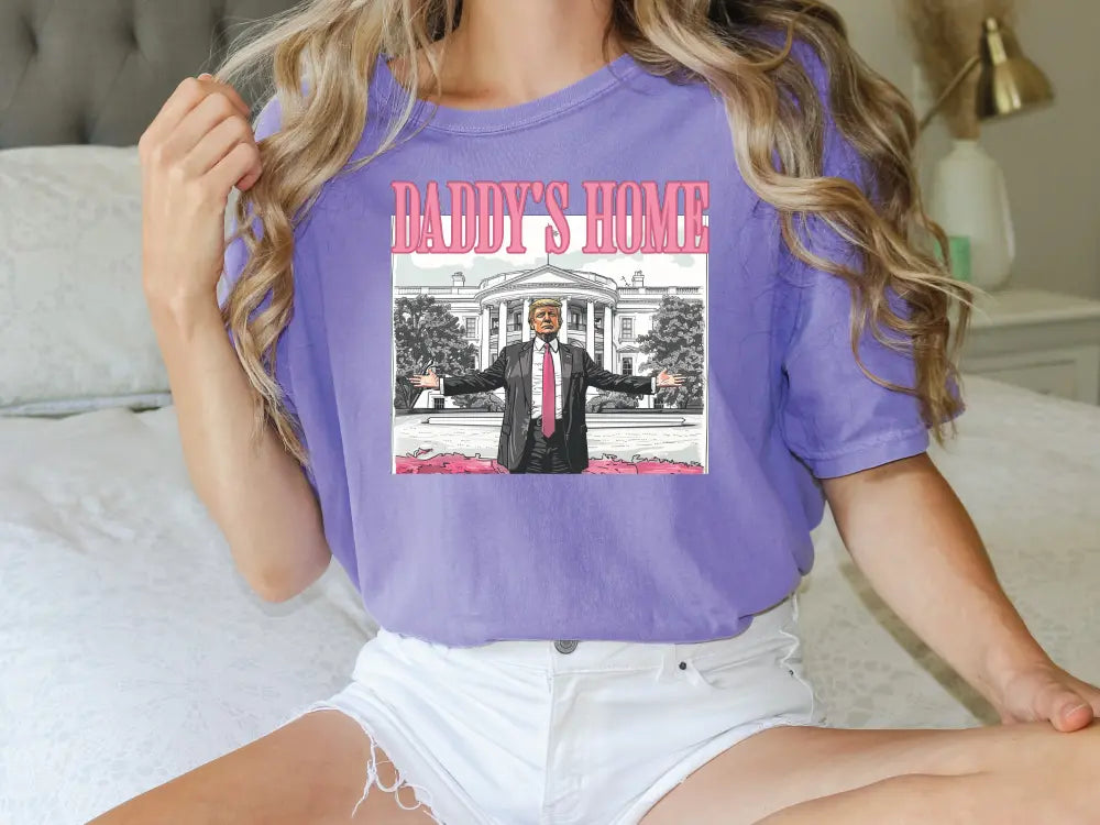 a woman sitting on a bed wearing a purple shirt and white shorts