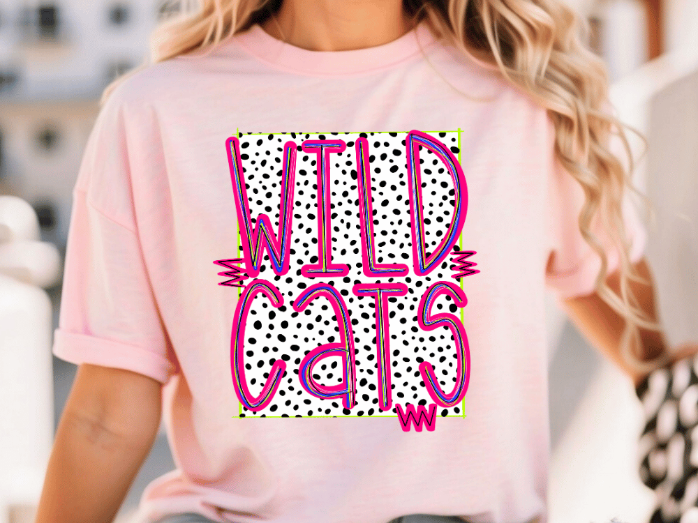 A woman wearing a pink t-shirt with the text "WILD CATS" printed on it.