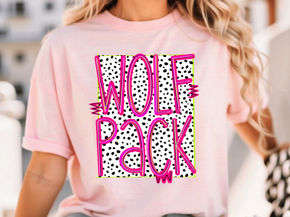 A woman wearing a pink t-shirt with the text "WOLF PACK" printed on it.