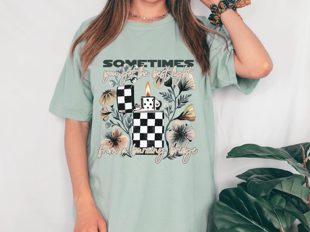 a woman wearing a t - shirt with a checkered candle on it