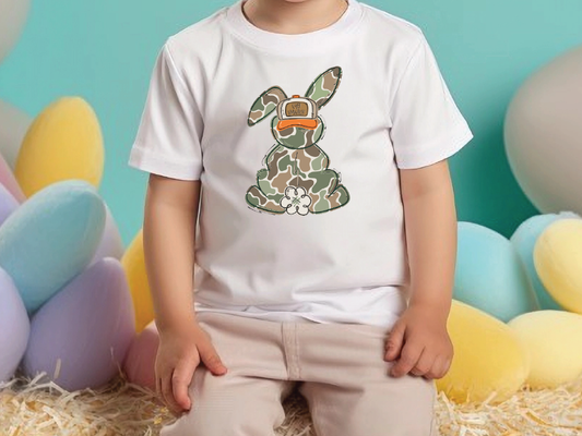 a little boy sitting on a pile of hay