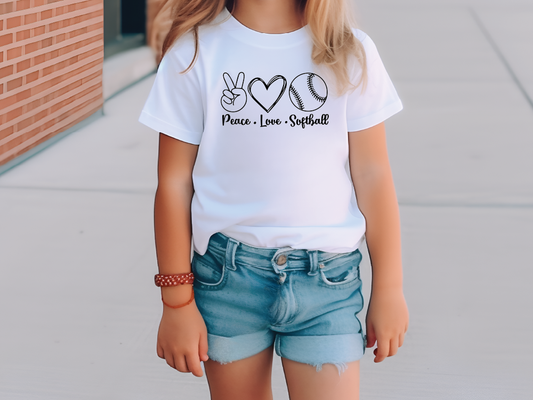 a little girl wearing a peace love softball t - shirt