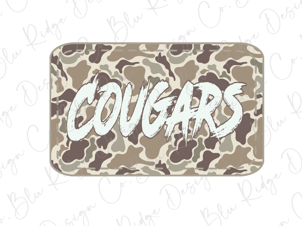 A camouflage-patterned rectangular object with the word "COUGARS" written in bold white letters on it.
