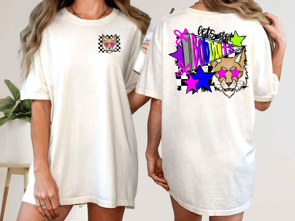 A white t-shirt with a colorful graphic design on the back, featuring a cat wearing sunglasses and surrounded by stars and other abstract shapes.