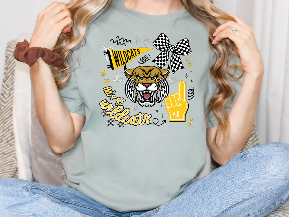 A woman wearing a grey t-shirt with a graphic design featuring a tiger and various text elements.